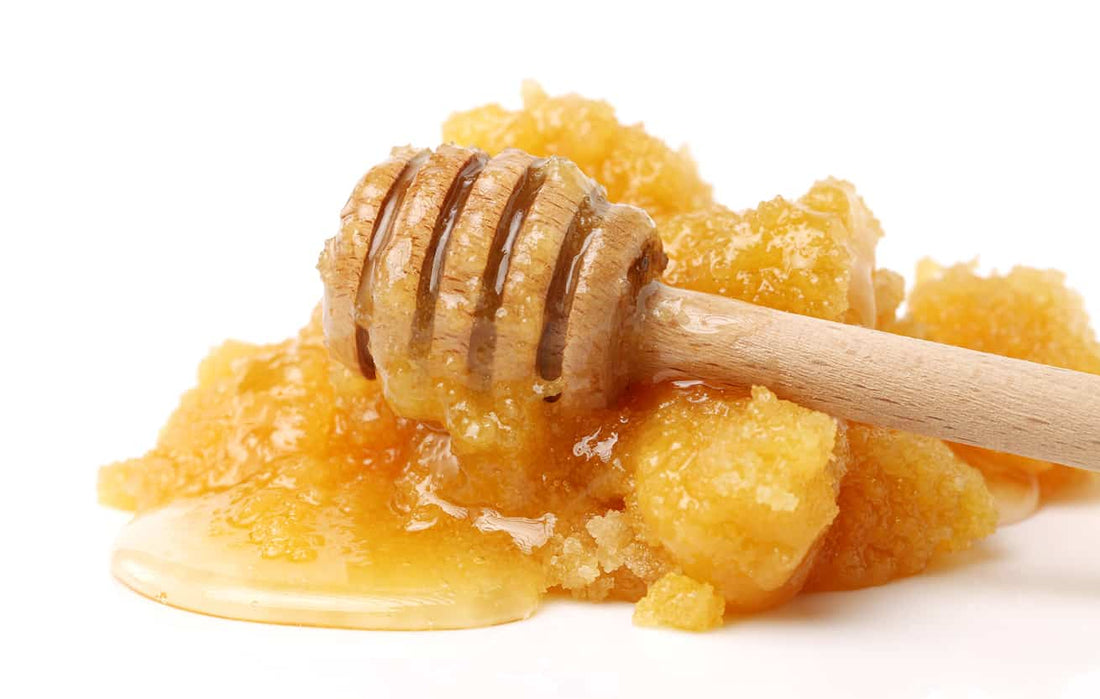 Crystallised honey in a jar with a spoon